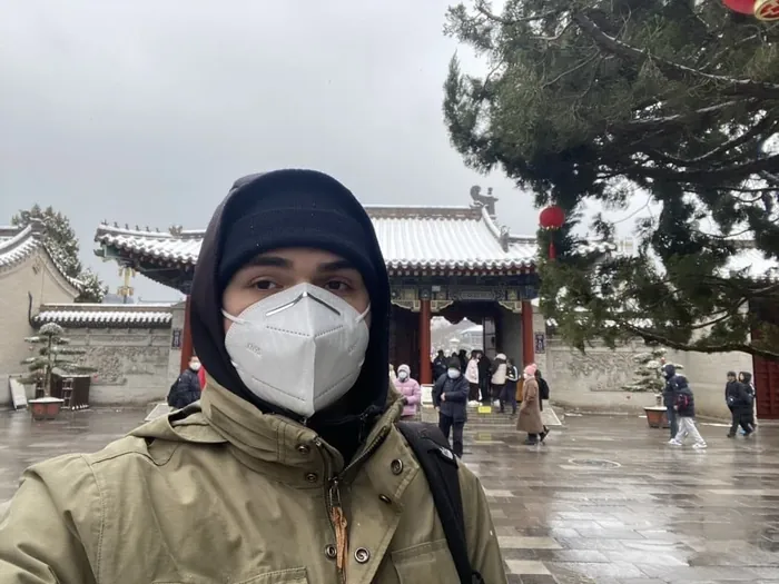 Szymon in a winter jacket and face mask